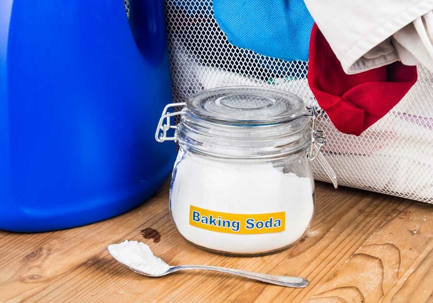 500-baking-soda-with-detergent-and-pile-of-dirty-laund-PMTWJY8