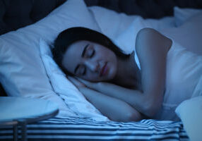 Young Woman Sleeping In Bed At Night. Sleeping Time Young woman sleeping in bed at night. Sleeping time