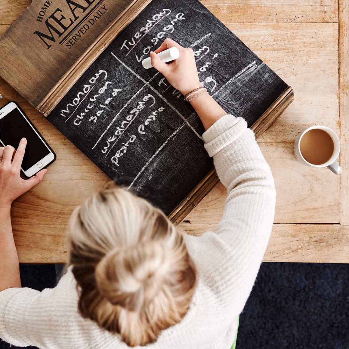 overhead-shot-looking-down-on-woman-at-home-writin-ED2ZMNP